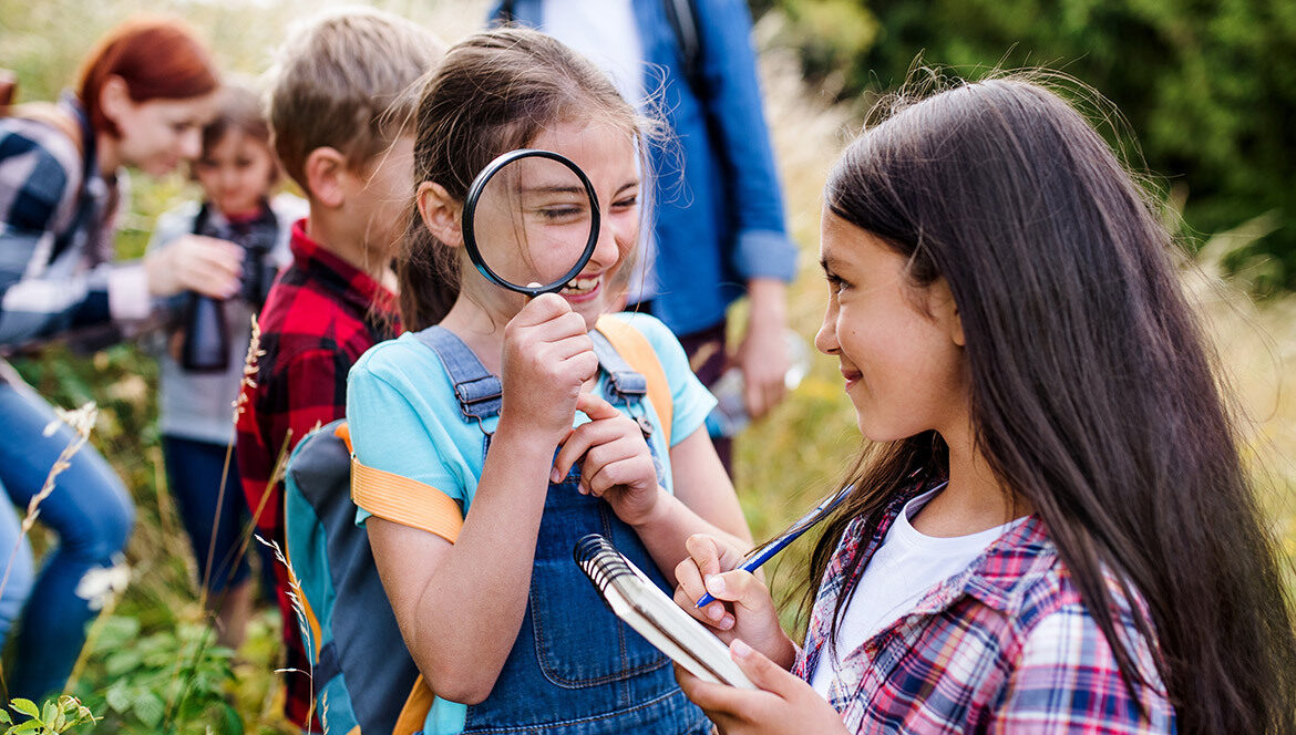 Missouri Department of Conservation photo of students with magnifying glass